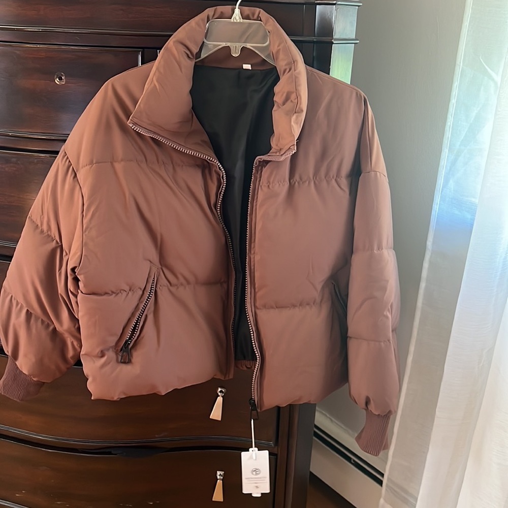 Brown jacket still with tags, size small never worn